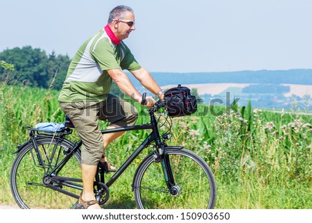 Elderly cyclist in nature