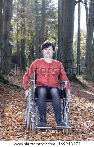 Wheelchair user in autumnal park