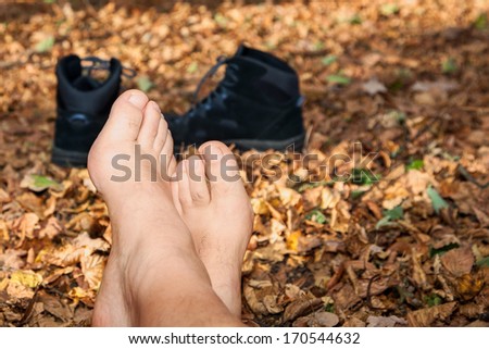 Shoes and Bare feet in autumn leaves