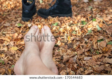 Shoes and Bare feet in autumn leaves