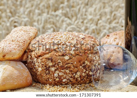 Bread and wine glass in front of the cereal box