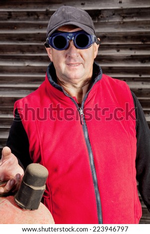Construction worker with gas bottle