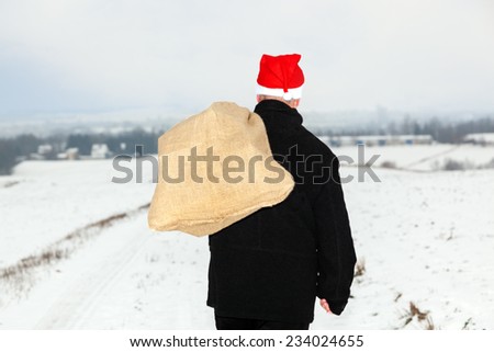 Man with cloth bag runs through the snow