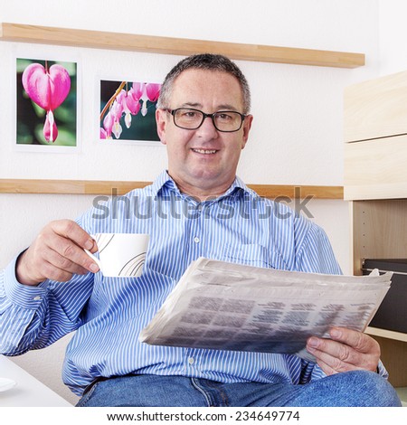 Man reading the newspaper in his spare time