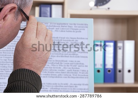 Man with glasses looking at screen