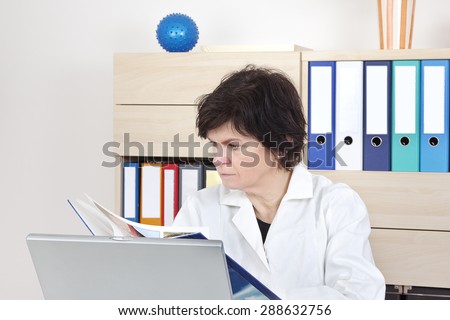 Family doctor in the meeting room reads the book