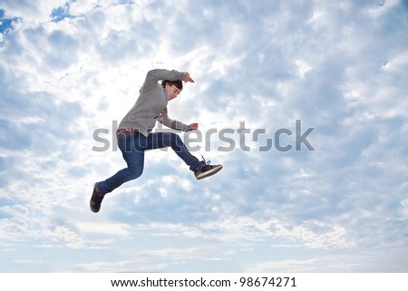 Young man jumping for joy in the air