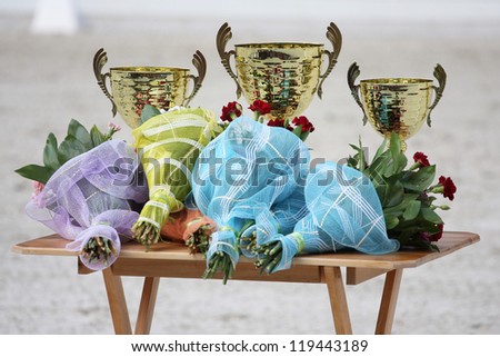 Golden trophy cups and flowers