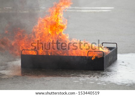 Fire flame in container on fire safety training