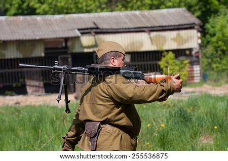 Kyiv, Ukraine - May 8 ,2009: Military soldier holding soviet machine gun  Degtyaryov during the Second World War on the history Military reconstruction in Kyiv. History club Red Star.