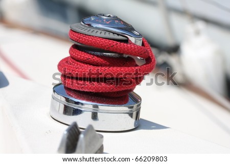 Winch and red rope on a sailboat