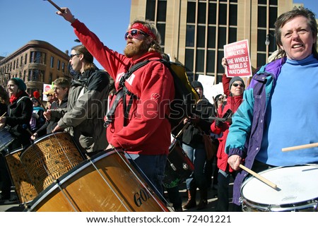 MADISON, WI - FEB 19: Unidentified people protest WI Budget Repair Bill on February 19, 2011 on the capitol square in Madison, WI.  The drummers lead many people marching in protest of the bill.