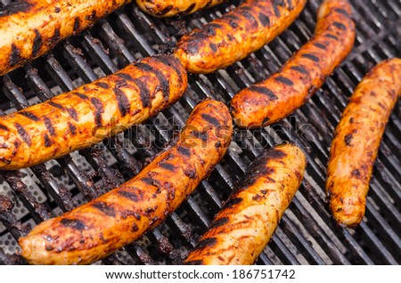 Sausage covered in sauce on grill