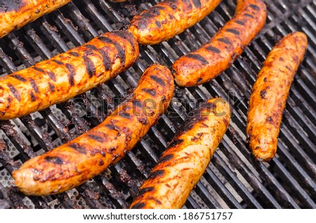 Sausage covered in sauce on grill