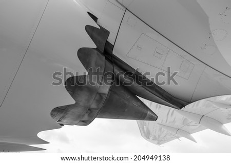 Black & White close up of the underside of a jet airplanes turbine burner