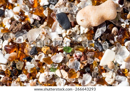 Abstract close up of the sand & colorful polished glass at Glass Beach on Kauai, Hawaii