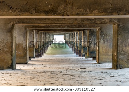 Abstract view from underneath a pier with long exposure to smooth out the waves & bring in colors