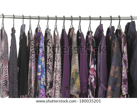 Row of colorful female fashion clothing on hanging