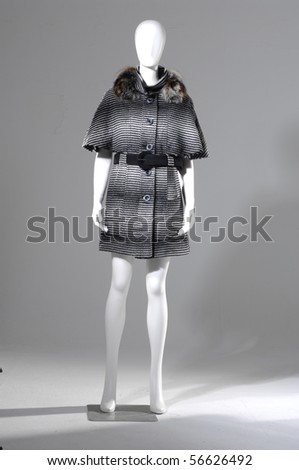 Beautiful female black and white fur coat on a light background