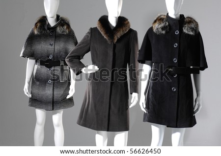 Three dummies dressed in black and white fur coat