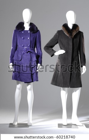 Winter fashion coat dress on mannequin in gray background