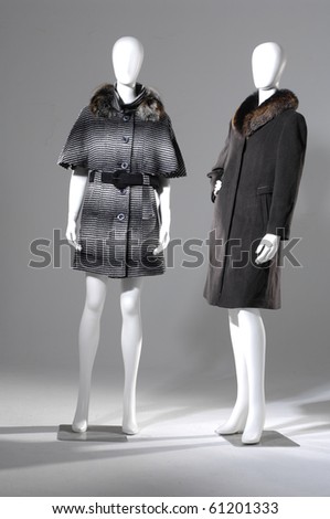 Two female winter fur coat on light background