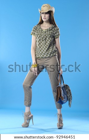 Full length photo of young woman with handbag on blue background