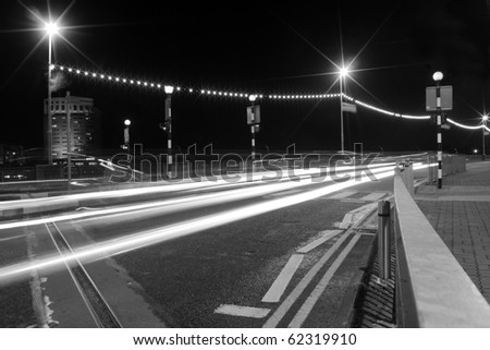 Cars moving past a pedestrian crossing, creating lines of light at Shannon Bridge Limerick city Ireland.