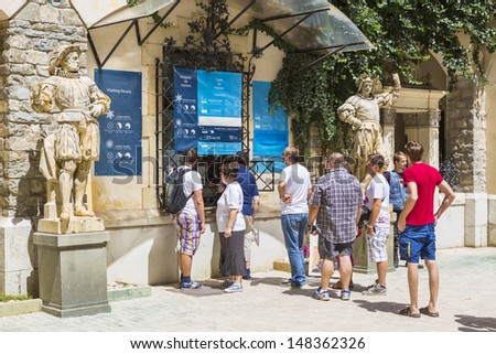 SINAIA, ROMANIA - JULY 24: Unidentified group of tourists wait in line to buy tickets for guided visiting tour at famous Peles castle on July 24, 2013 in Sinaia, Romania.
