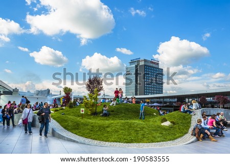 BUCHAREST, ROMANIA - MAY 1: Unidentified people relax at recreation area in Promenada Mall on May 1, 2014 in Bucharest, Romania. The mall received Building of the Year SEE 2014 at CEEQA Gala, Warsaw.