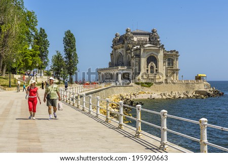 CONSTANTA, ROMANIA - MAY 25: Unidentified tourists enjoy a walk on old Casino sea wall on May 25, 2014 in Constanta, Romania. Casino is one of the most representative symbols of the city.