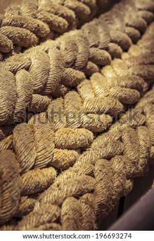 Closeup of worn vintage marine ropes on old sailing vessel. Shallow depth of field.