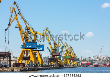 CONSTANTA, ROMANIA - MAY 25, 2014: Heavy load cranes on rails on the quay of industrial port of Constanta, the largest port on the Black Sea and the 18th largest in Europe.