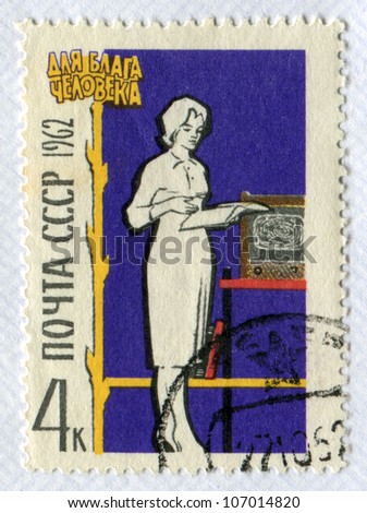 USSR - CIRCA 1962: Postage stamp printed in the Soviet Union shows a woman reading a book. Culture of everyday life. Slogan - For the benefit of man, circa 1962