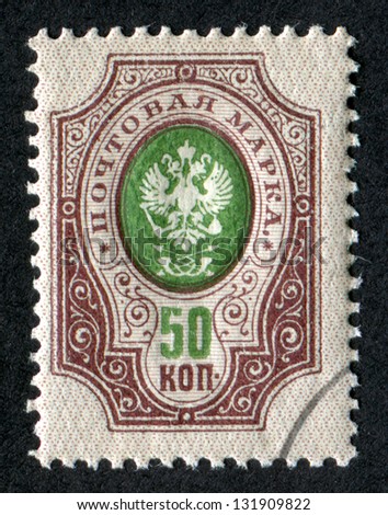 RUSSIA - CIRCA 1905: A stamp printed in Russia shows Imperial Eagle and Post Horns with Thunderbolts. Scott Catalog 66 A8 50k violet & green, circa 1905