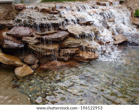 a landscaped waterfall made of stacked rocks