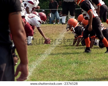 photo of football players of opposing teams facing off on the field
