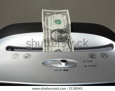 concept photo of a dollar bill being shredded by a paper shredder depicting the weakened dollar value