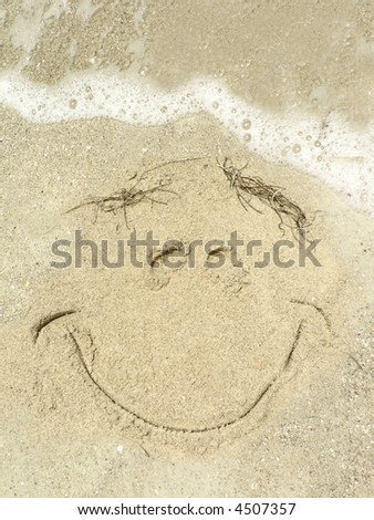 close up of smiley face drawing on a  Gulf Coast Florida beach