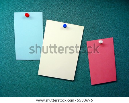 three blank memos posted on the wall of a modular office cubicle