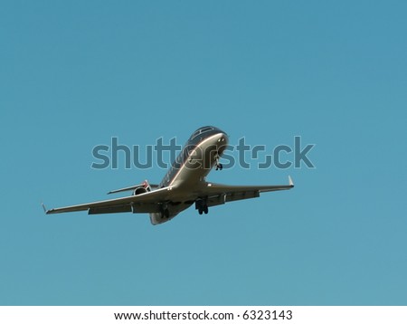 commercial jet in flight with a bright blue sky in the background. copy space included