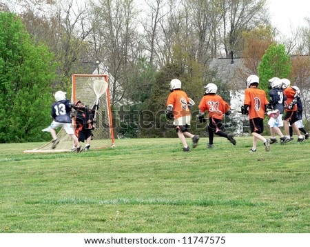 A game of Lacrosse being played. All identifying marks have been removed! Action blur is applied to the shot!
