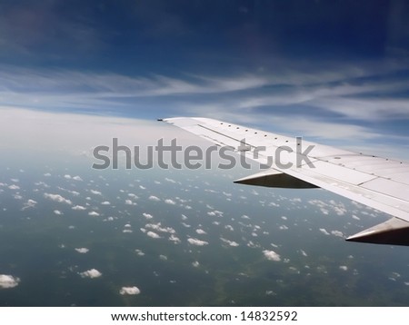 aerial view as seen from an airplane of the sky and land below