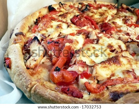 photo of a open pizza box with chicken topped thick crust pizza inside