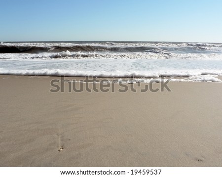 photo of a foamy surf on Virginia Beach that includes copy and crop space