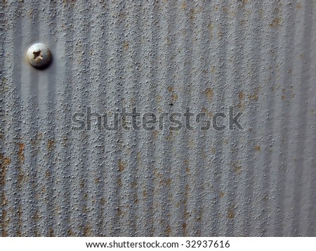 macro background of a rusty painted sheet metal panel which can be used as a backdrop image for design work