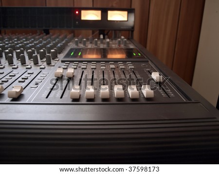 photo of channel volume controls of a recording studio mixing console