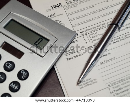 conceptual photo of a US 1040 Income Tax Form for tax preparation and accounting services related subject matter.