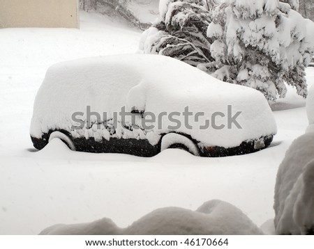 photo of a snow covered vehicle in home driveway during the winter snow blizzard of 2010 that fell on the Mid Atlantic region of the United States