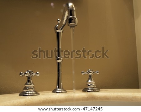 a contemporary style bathroom faucet with a marble base